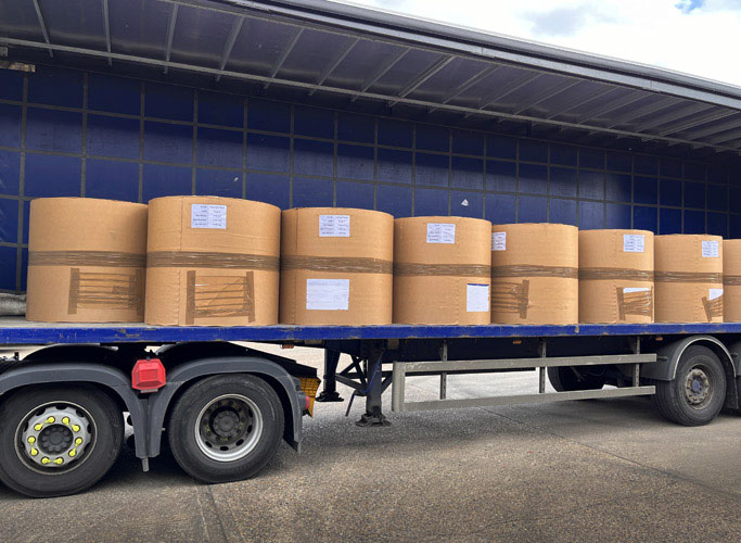 Paper reels loaded onto trailer